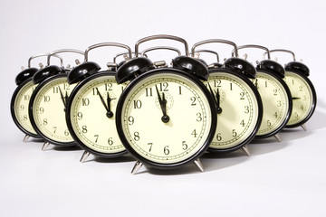 Multiple retro alarm clocks isolated on white.
