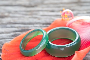 Jade ring and petal red on wooden, Concept of love.