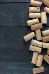 Wine corks on dark wooden texture with copyspace