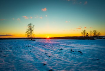 Fototapeta na wymiar Sunset over winter snow fields