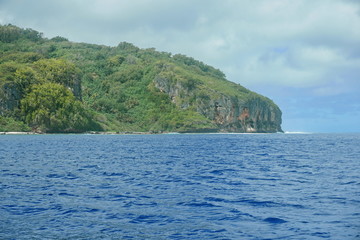 Wild coast of Rurutu island with cliff and tropical vegetation, French Polynesia, south Pacific ocean, Austral archipelago
