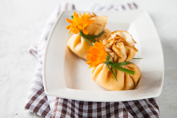 pancake sacks with a cottage cheese and fruit stuffing in a plate on a table, selective focus, copy...