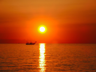 Fototapeta premium Fiery sunrise at Italian beach. Summer season. Emilia Romagna region. Adriatic sea. Italy