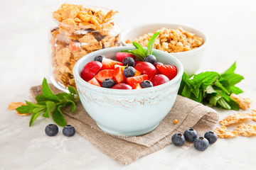 muesli with berries in a bowl on a table, selective focus