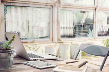 Outdoor work table with laptop computer, tablet, phone, and othe