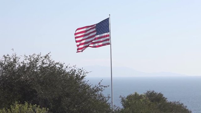 American and USA flag Union waving in front of blue sky