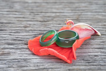 Jade ring and petal red on wooden, Concept of love.