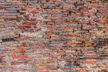 Weathered texture of stained old dark brown and red brick wall t