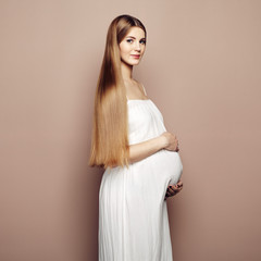 Portrait of the young pregnant woman. Pregnancy, love, people and expectation concept. Happy...