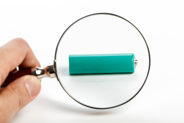green battery and magnifying glass