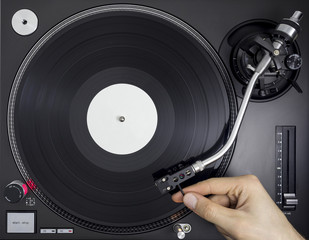 DJ Turntable, Hand Placing Tonearm on Vinyl Record, Top View © ss_comm