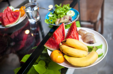 Tropical fruits and salad breakfast