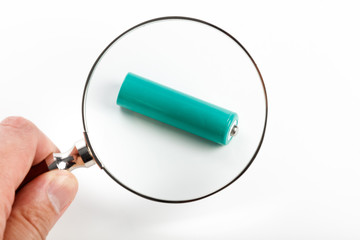 green battery and magnifying glass