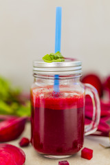 Healthy beetroot juice in a mason jar mug on grey stone background. 