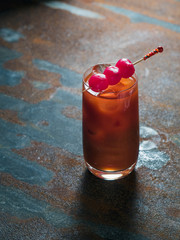 Red Cocktail (Bloody Mary) in a smooth glass with tree pink marinated onions on top, rusty background. Vertical photo, back light