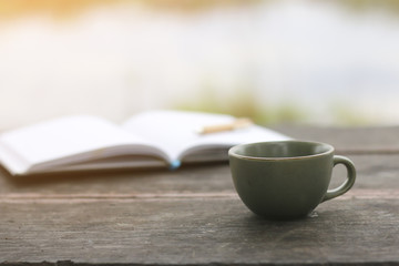 Stock Photo:.coffee cup with notebook on wooden table
