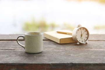 Stock Photo:.coffee cup with notebook on wooden table