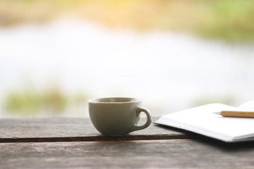 Stock Photo:.A cup of coffee on the wood table