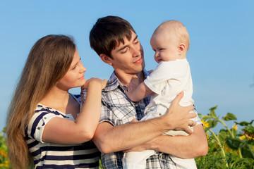 Happy family playing in park at the day time.