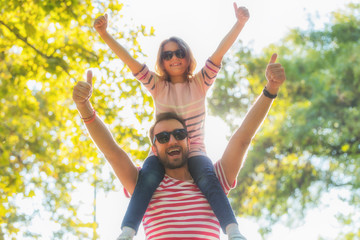 Father and daughter enjoying in the park.
