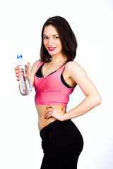 Young woman in sportswear with a bottle of drinking water