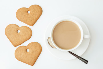 Valentine's day card. Breakfast. White mug of hot coffee with milk and cookies on white background. Top view.
