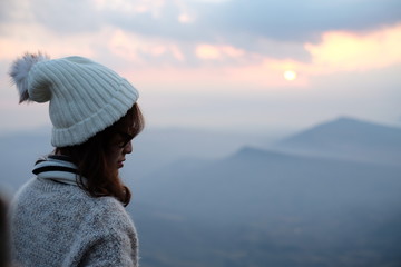 woman back looking at mountain view with sunrise sky in the winters