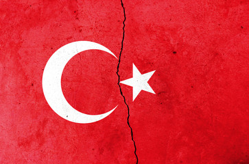 A crack in the wall. Turkish flag in the background