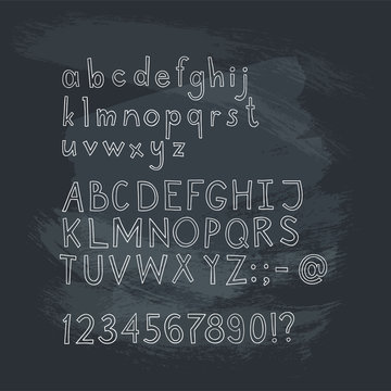 Vector hand drawn doodle font isolated on chalk blackboard. Sketch alphabet