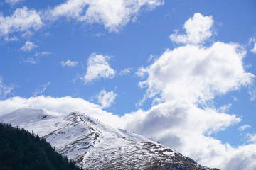 Snow capped mountain set to a backdrop of the sky - 133174954