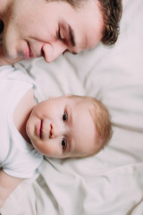 Portrait of loving father with baby boy 4-6 months his son at ho