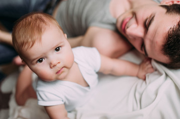 Portrait of loving father with baby boy 4-6 months his son at ho