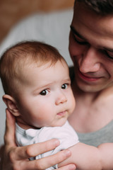 Portrait of loving father with baby boy 4-6 months his son at ho