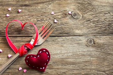 Two forks and red hearts