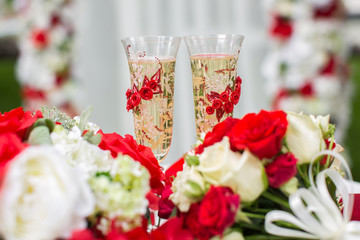 The champagne glasses. Wedding ceremony outdoors. Bouquet with r