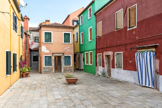 Small square with colorful houses in Burano (Italy)