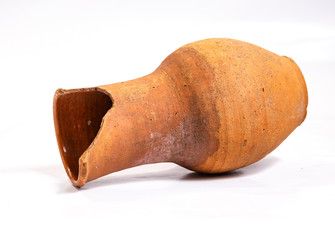 Old broken jug for milk on a white background