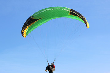 Paraglider in a blue sky