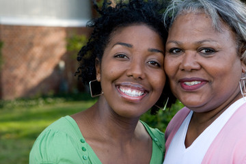 Happy African American mother and her daugher.