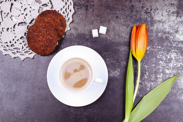 Coffee cup, cookies and tulips