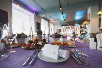 Dining table setting at Provence style, with candles, lavender,