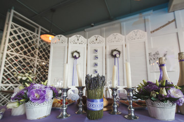 Dining table setting at Provence style, with candles, lavender,