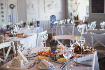 Dining table setting at Provence style, with candles, lavender,