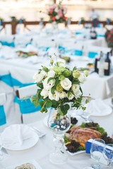 Table setting at a luxury wedding reception. Beautiful flowers o