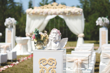 White wedding tent for the ceremony outdoors. Arch. Chairs. The