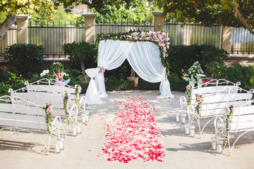 Wedding ceremony outdoors. Wedding arch in white with fresh flow