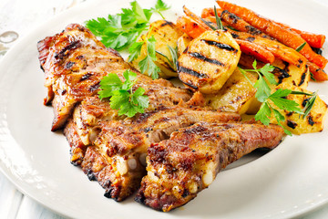 Grilled Pork Ribs and Fried Potatoes on White Plate