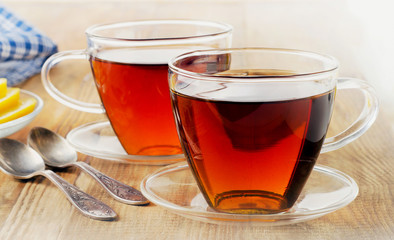 Glass cups of  black tea with lemon.