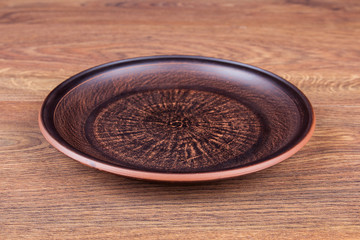 Brown clay plate on the table