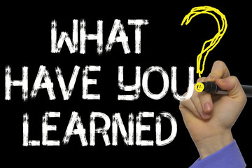Hand writing the text: What Have You Learned